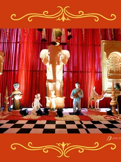 A sacred corner dedicated to Lord Ganesha, surrounded by traditional Indian figures and a checkered floor. This space is designed to bring blessings to the new couple.