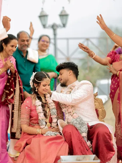 Family members shower blessings on the couple during a key moment in the wedding ceremony.
