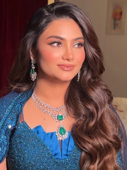 A beautiful candid shot. The makeup is designed to look flawless from every angle, ensuring she is picture-perfect all night long.