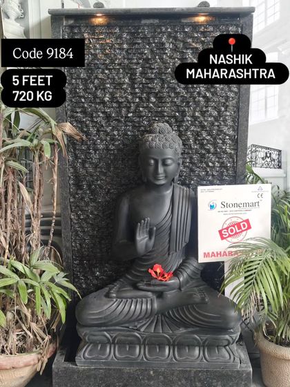This 5-foot, 720 kg Buddha fountain is a substantial and impressive piece. The combination of the serene black marble Buddha and the textured granite waterfall makes it a modern masterpiece.