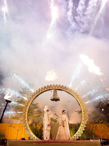 A spectacular varmala moment captured under a sky of fireworks. This is the kind of grand, 'wow' shot I live for, freezing a moment of pure celebration and magic that you will remember forever.
