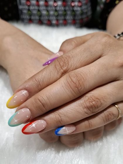 The full set of the rainbow French tip nails, showing the spectrum of colors across the hands.