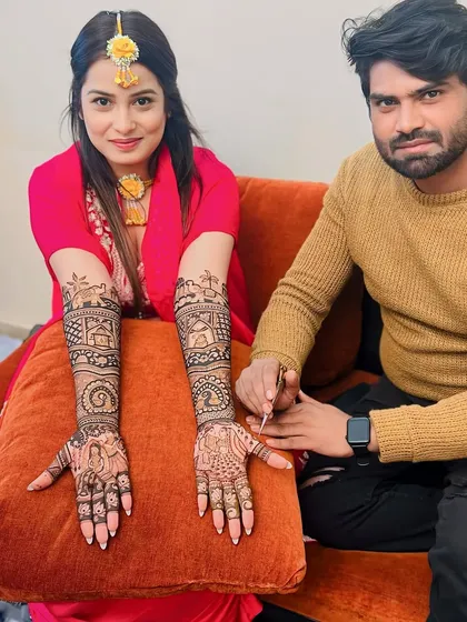 With a client showcasing her completed bridal mehandi. We work closely with our clients to create the design of their dreams.
