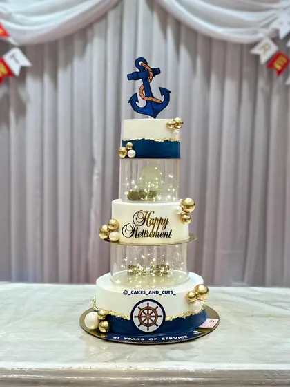 A professional shot of the Navy-themed retirement cake, highlighting its height and intricate details.