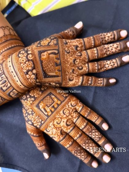 A detailed back-hand design featuring elephant motifs inside decorative squares.