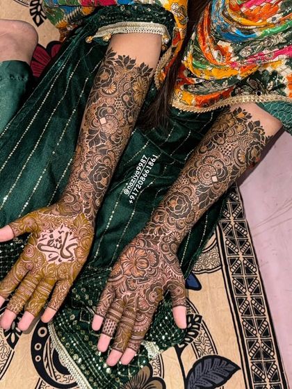 An engagement bride's henna, featuring her partner's name in calligraphy.