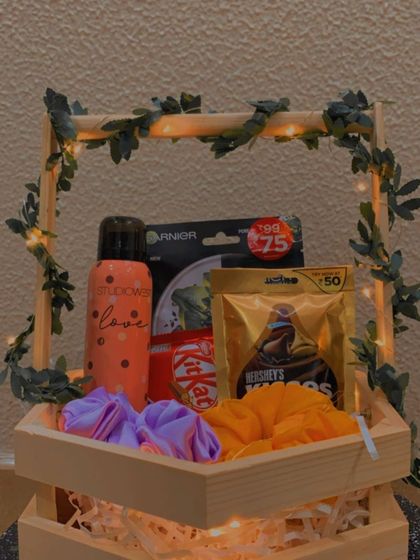 The warm lighting in this photo gives the hexagon hamper a cozy and inviting feel, perfect for a relaxing self-care themed gift.