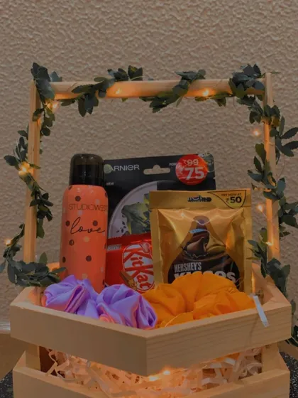 The warm lighting in this photo gives the hexagon hamper a cozy and inviting feel, perfect for a relaxing self-care themed gift.