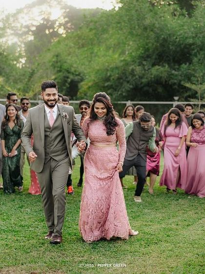 Ameera and Richard walking with their friends and family behind them. This shot captures the feeling of being surrounded by the love and support of your community.
