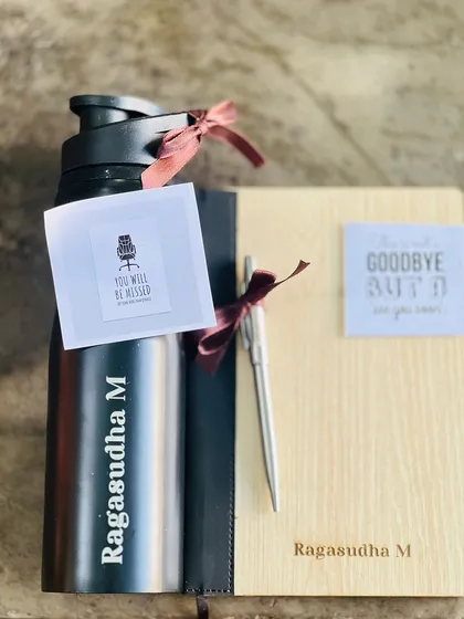 Personalization makes a gift truly memorable. This farewell gift set includes a water bottle and a wooden notebook, both engraved with the employee's name for a thoughtful and personal touch.