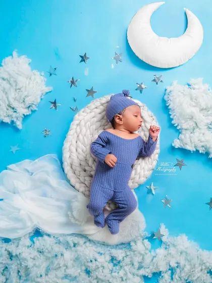 I love bringing dreamy concepts to life. For this newborn session, I designed a celestial theme with a soft moon, fluffy clouds, and twinkling stars, creating a peaceful, sky-like setting for this sleeping baby boy.