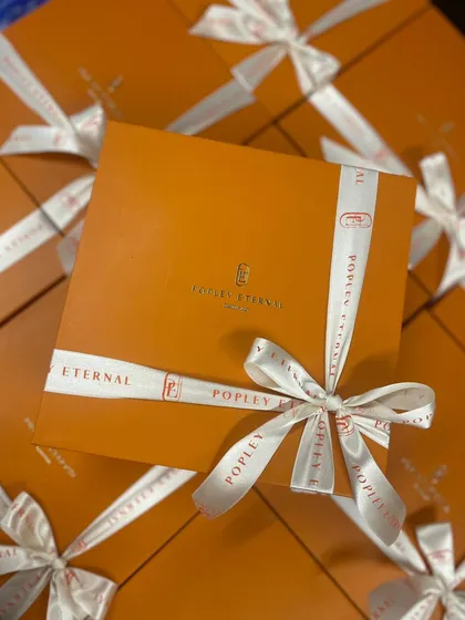A great example of our custom branding work for a client. We designed these elegant corporate gift boxes with custom logo ribbons for Popley Eternal, ensuring their brand was front and center. I love making sure every detail, from the box to the bow, reflects your company's style.