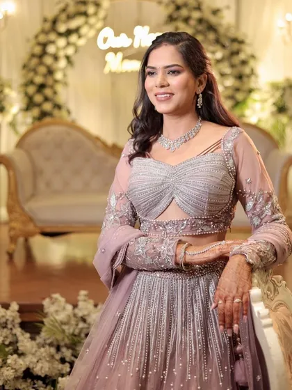 For her engagement, this bride wanted to look like the best version of herself. We created a soft, dewy, and glamorous look with a beautiful braided hairstyle that perfectly suited her elegant pastel lehenga.