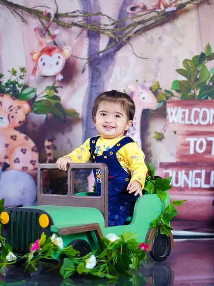 This little adventurer is all smiles as he stands in his jeep, ready to explore the wild.