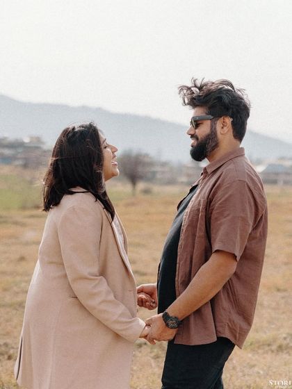 A candid moment of conversation and connection between the couple, set against the rolling hills of Dharamshala.