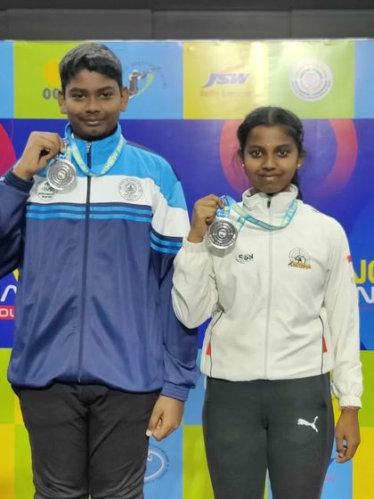 Jonathan and his partner proudly display their silver medals from the mixed team event.