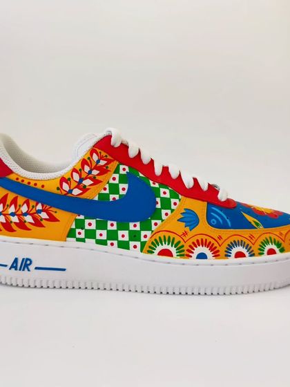A side view of the custom mismatched Indian art sneakers. You can see how the different patterns, from floral motifs to geometric checks, come together. I love playing with primary colours to make the designs pop.