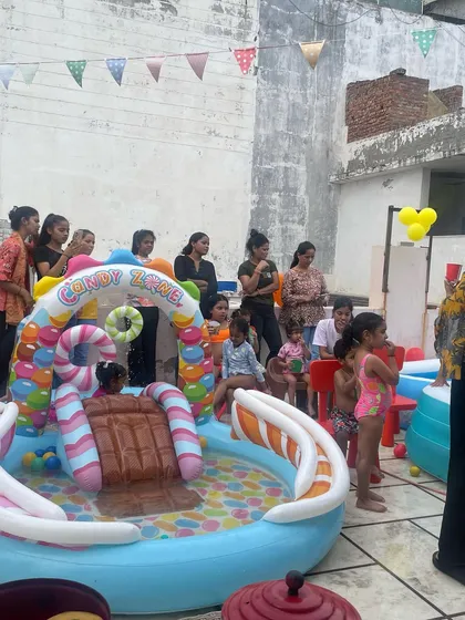 I also organize themed parties like this fun pool party for kids. The setup includes an inflatable water slide and pool for the children to enjoy.