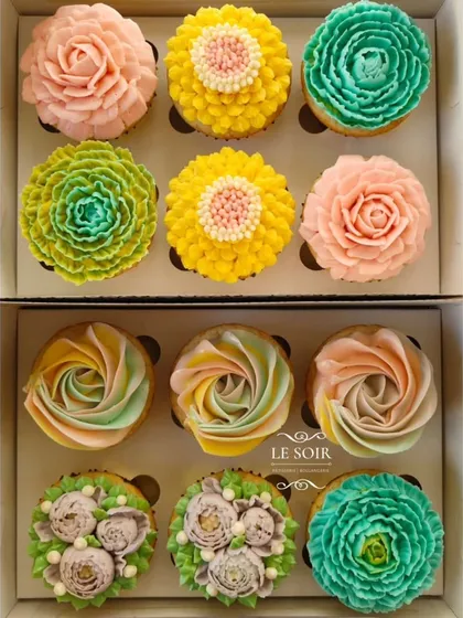 A whole garden of eggless cupcakes. This shows the variety of floral designs I can create using my less-sweet buttercream, from delicate rosettes to vibrant, multi-layered blossoms. Each one is piped by hand.