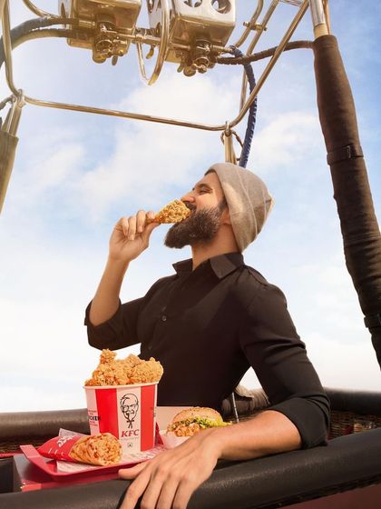 Up in the air for a KFC campaign with Vijay Deverakonda. The styling is simple and dark to make the iconic red KFC bucket pop, keeping the focus entirely on the product.
