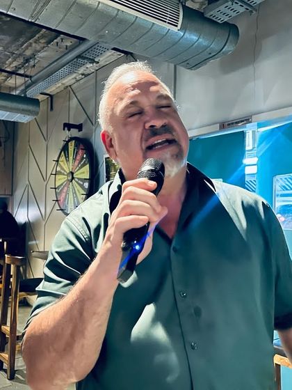 Our stage welcomes everyone, including this surprise guest from Texas who brought his powerful voice to our karaoke night.