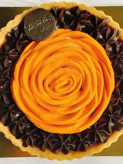 A surprising and delicious combination: my Dark Chocolate & Mango tart. The rich, slightly bitter chocolate pairs beautifully with the sweet, tropical flavor of the mango rose.