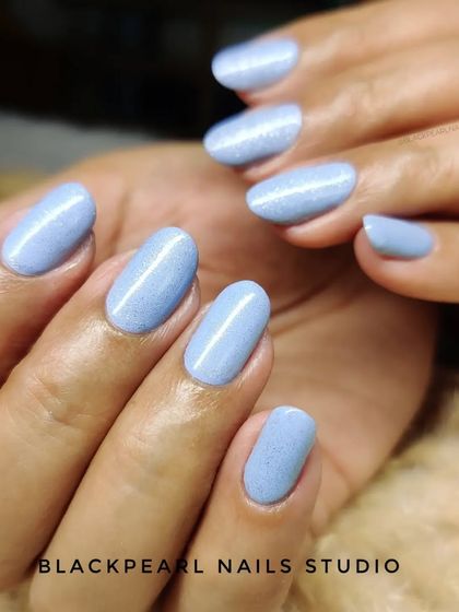 Another angle of the BIAB nails with light blue glitter, highlighting the durability and beautiful finish that this service provides for natural nails.