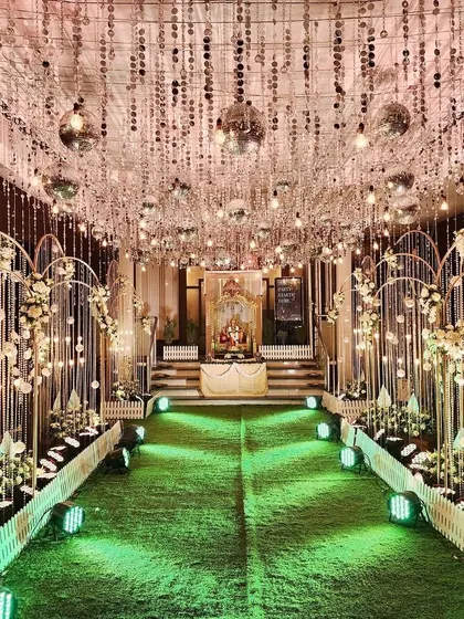 For a night of glamour and dancing, I designed this shimmering silver-themed Sangeet entrance. The ceiling is covered in disco balls and crystal strings, creating a dazzling effect that sets the perfect mood for a high-energy party.