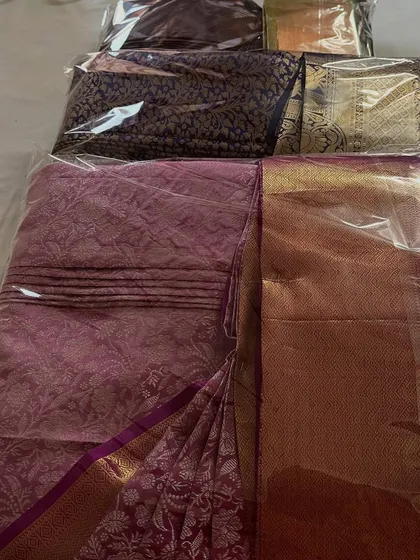 Getting a batch of customer sarees ready for delivery. Each one is folded and packed in its own protective cover to maintain the pleats and prevent any damage during transport or storage.