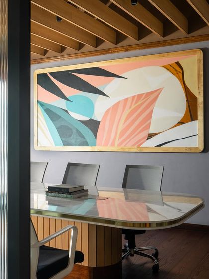 The meeting room at Citadines is a vibrant and inspiring space. A large, colorful abstract artwork and a custom-designed table with a brass-inlaid top create a sophisticated environment for business discussions.