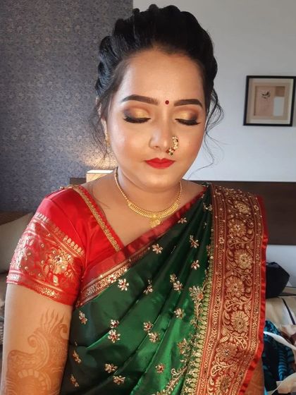 This angle shows the elegant braided hairstyle and the flawless skin finish that looks fresh and natural.