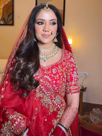 All dolled up and ready for her big day. We went with a soft glam makeup look and romantic waves to complement her traditional red bridal outfit.