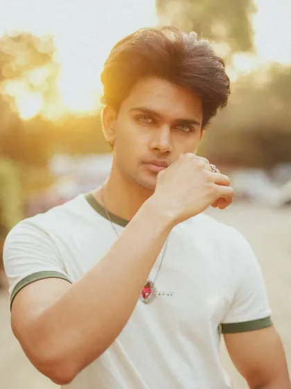 An outdoor portrait for a male model, using the natural glow of sunset to create a strong yet approachable headshot. This style is great for actors and models who need portfolio images that look authentic and professional.