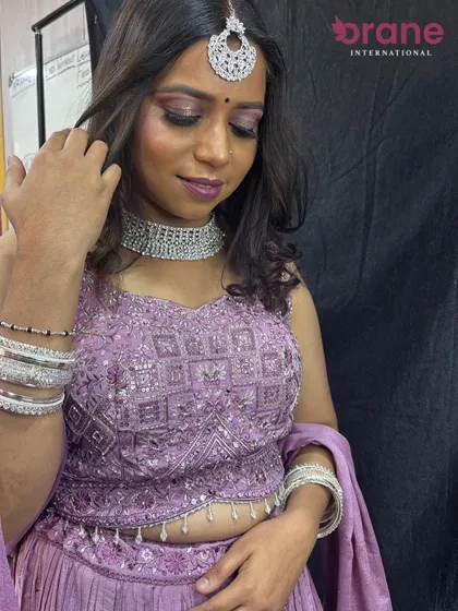 This shot shows the full outfit, including the stylish crop top and flowing lehenga, perfect for a modern bride.