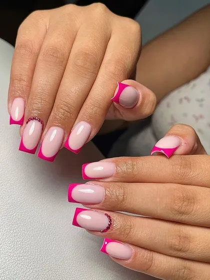 A vibrant pink French manicure on long square nails. I added a subtle touch of sparkle with a rhinestone accent at the base of two nails.