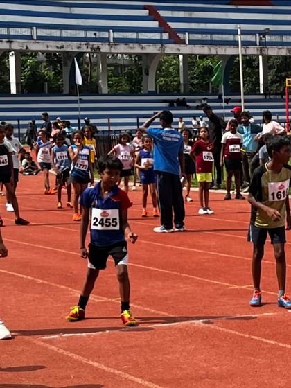 Young athletes at the starting line, focused and ready to race at the Karnataka Athletic Association meet.