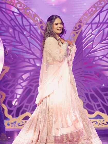 A beautiful bride solo with butterfly wing props, adding a touch of whimsy and magic to her performance. This was part of a modern fairytale theme we designed.