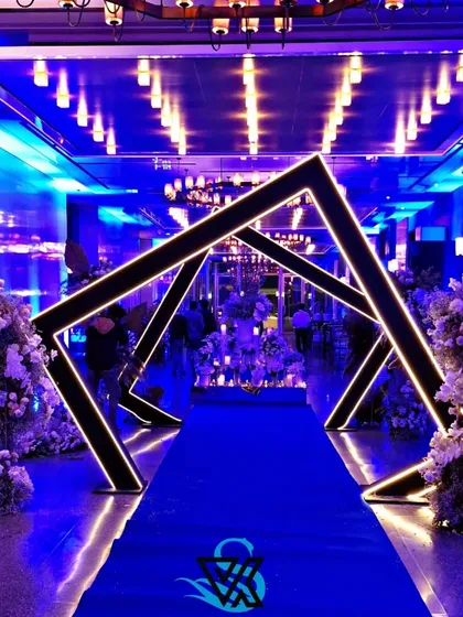We love creating modern, high-impact designs for cocktail parties and corporate mixers. This geometric entrance tunnel, lit with a cool blue glow, provided a futuristic and exciting pathway for guests, setting a vibrant mood from the moment they arrived.