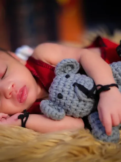 Even the tiniest wizards need their sleep. This newborn is dreaming of magical adventures, cuddled up with a teddy bear and holding a miniature wand.