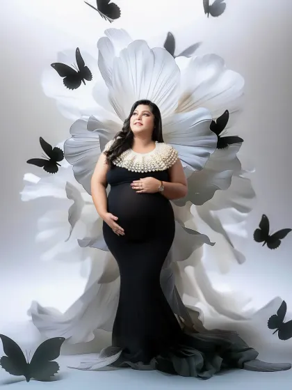 A stunning monochrome concept with a giant white paper flower and black butterfly accents. The contrast creates a bold, artistic, and fashionable statement.