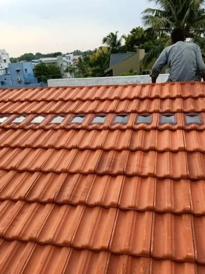 Our skilled team is shown here carefully installing roof tiles on a pergola structure. We ensure every element is perfectly placed for a durable and watertight finish that stands the test of time.