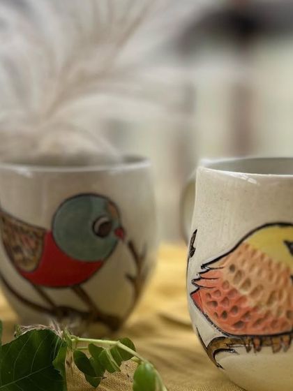 Another look at these colorful bird mugs. I love painting these little feathered friends, each one perched on a branch.
