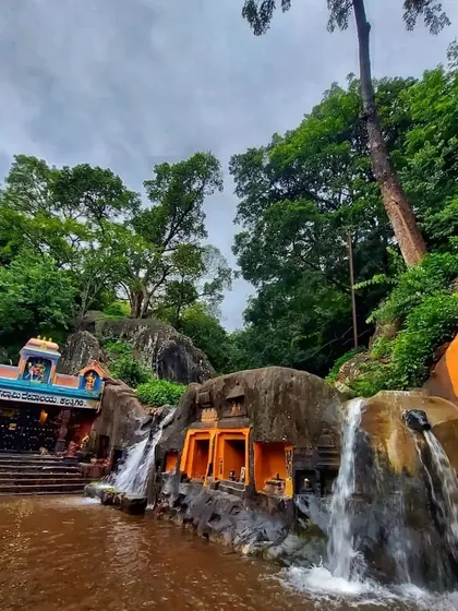The Kallathigiri Falls cascading over a temple structure in Chikmagalur. Our trips cover famous spots like Jhari falls, Mullayanagiri, and Baba Budan Giri.