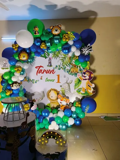 A square backdrop jungle theme with blue and green balloons. This design includes multiple cartoon animal cutouts for a playful look.