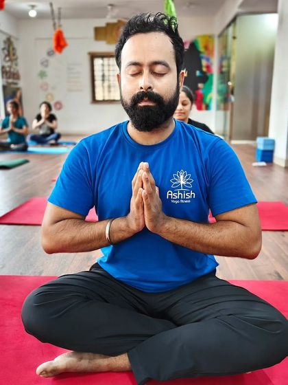 A practitioner embodies tranquility during a group meditation session.