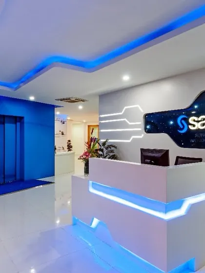 A futuristic reception desk we designed for SAS back in 2014. The use of integrated blue LED lighting and circuit board-inspired graphics on the wall created a tech-forward look that was ahead of its time.