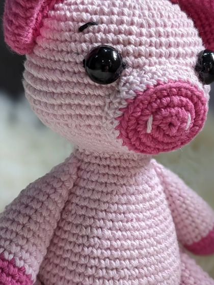 A close-up of the pink piglet, showing the spiral stitching on his snout.