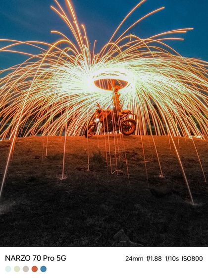 Another angle from the steel wool photography session, capturing the shower of sparks over the motorcycle.
