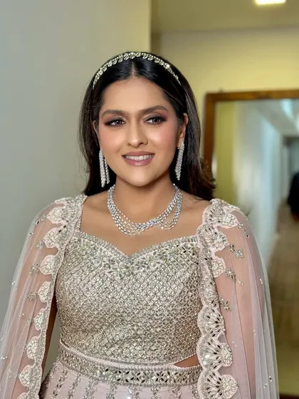 This portrait showcases the overall elegance of the look, from the makeup to the diamond jewelry and the chic outfit.