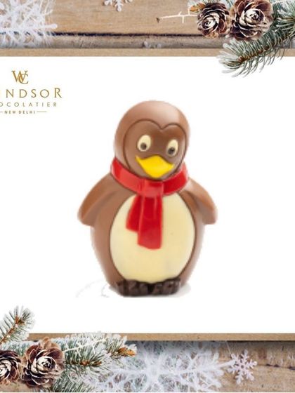 A clean, studio shot of my chocolate penguin sculpture, highlighting its smooth finish and hand-painted scarf detail.